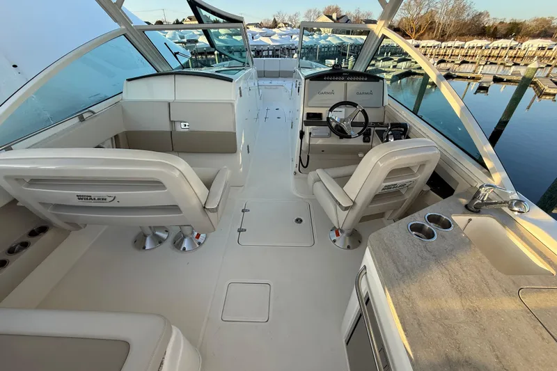  Yacht Photos Pics 2017 Boston Whaler 320 Vantage boat interior with helm, seating, and console.