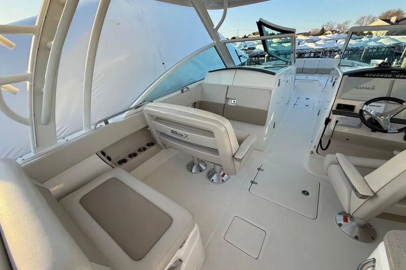  Yacht Photos Pics 2017 Boston Whaler 320 Vantage boat interior with seating and steering console.