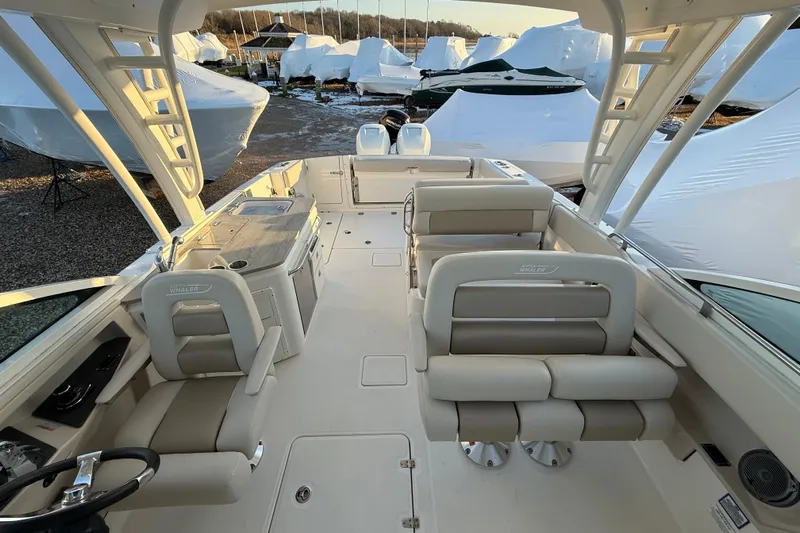  Yacht Photos Pics 2017 Boston Whaler 320 Vantage boat interior with seating and helm, docked outdoors.