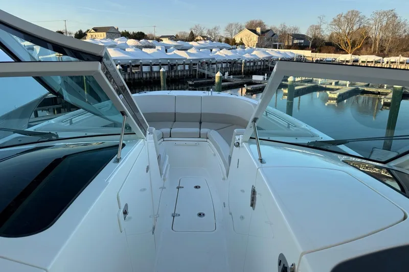  Yacht Photos Pics 2017 Boston Whaler 320 Vantage boat docked at a marina, showcasing spacious seating.