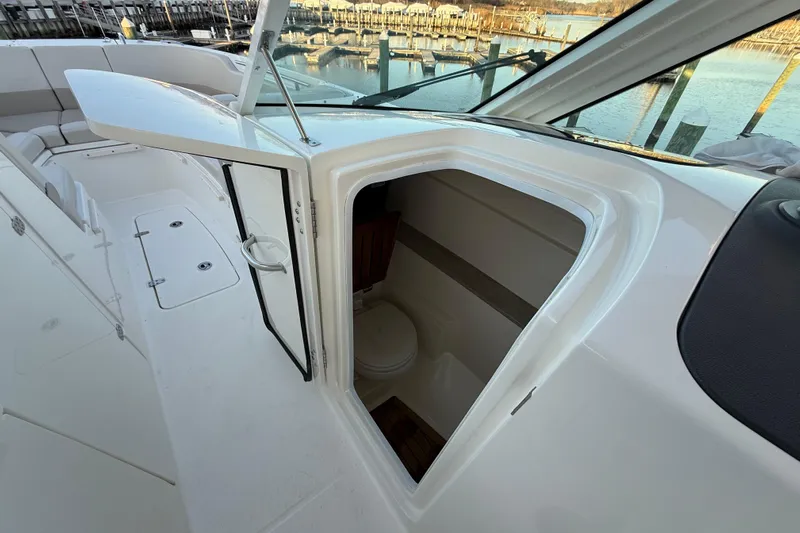  Yacht Photos Pics 2017 Boston Whaler 320 Vantage boat interior with open cabin door and visible seating.