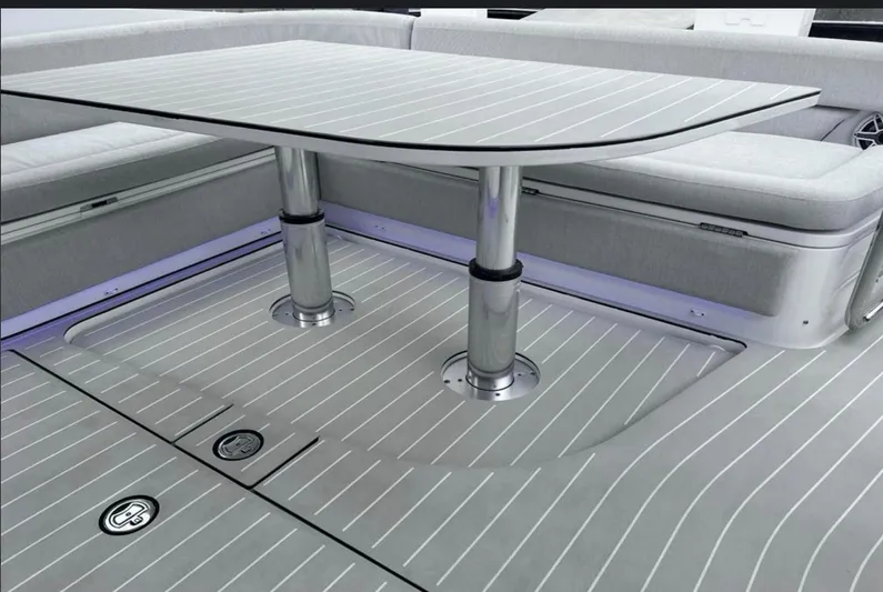  Yacht Photos Pics 2022 Azimut Verve 42 yacht interior with sleek table and cushioned seating.