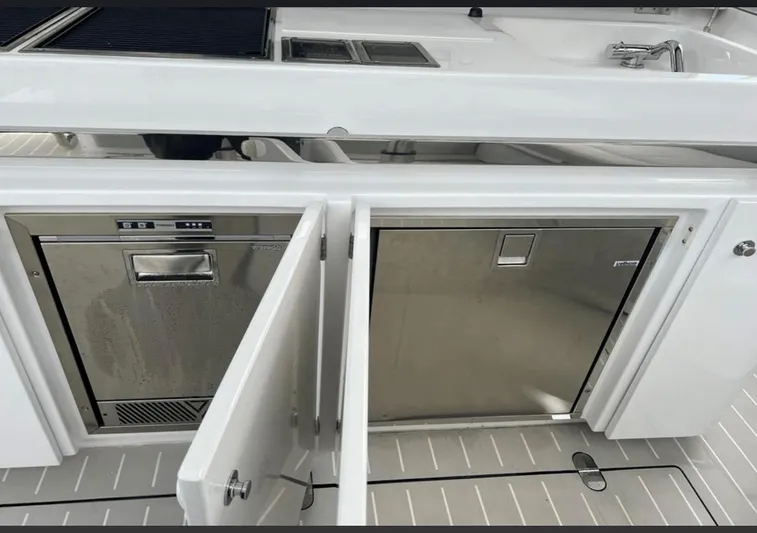  Yacht Photos Pics 2022 Azimut Verve 42 yacht kitchen with stainless steel appliances and sleek white cabinetry.