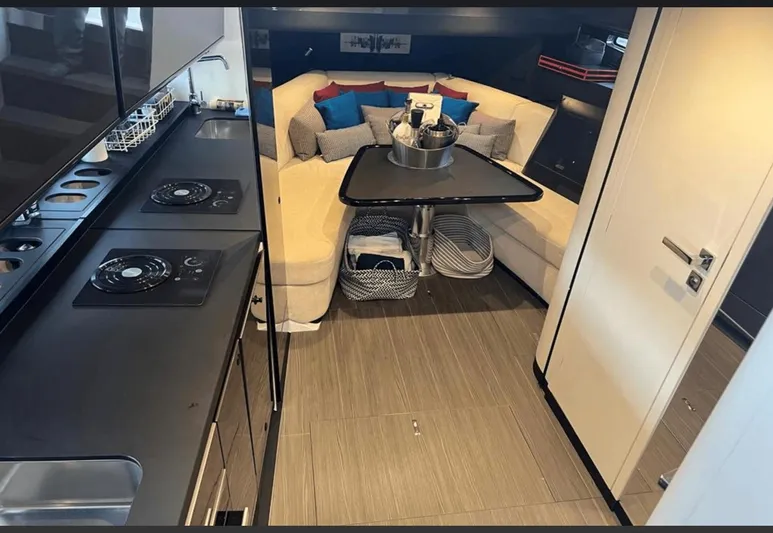  Yacht Photos Pics Luxurious interior of 2022 Azimut Verve 42 yacht with modern kitchen and cozy seating area.