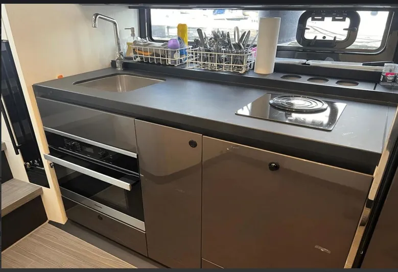  Yacht Photos Pics Modern kitchen in 2022 Azimut Verve 42 yacht with sleek appliances and countertop.