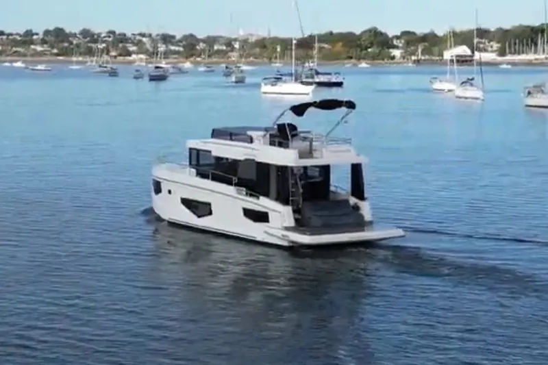 Your New Boat Yacht Photos Pics 2026 Cobra Yachts Sea Master 45 cruising in a serene harbor with other boats.