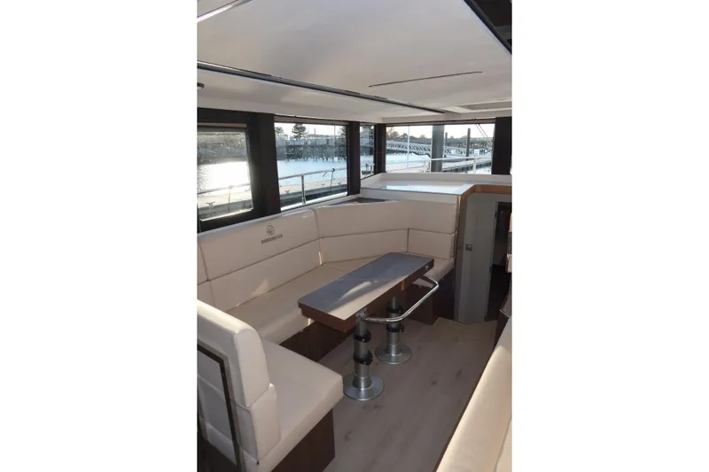 Your New Boat Yacht Photos Pics Luxurious interior of 2026 Cobra Yachts Sea Master 45 with elegant seating and table.