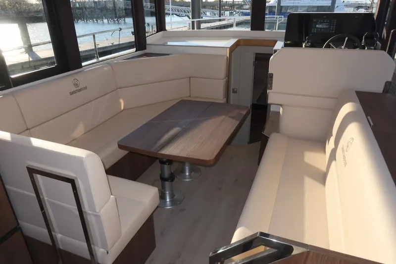 Your New Boat Yacht Photos Pics Luxurious interior of 2026 Cobra Yachts Sea Master 45 with elegant seating and table.