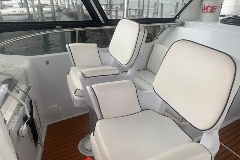  Yacht Photos Pics Interior of 1999 Hatteras 52 Cockpit Motor Yacht with white cushioned seating.