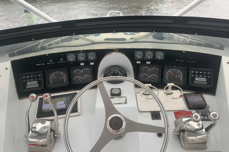  Yacht Photos Pics Cockpit view of 1999 Hatteras 52 Cockpit Motor Yacht with steering wheel and control panel.