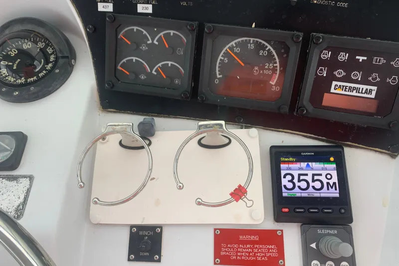  Yacht Photos Pics Control panel of a 1999 Hatteras 52 Cockpit Motor Yacht with gauges and navigation display.