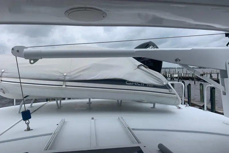  Yacht Photos Pics 1999 Hatteras 52 Cockpit Motor Yacht with covered dinghy on deck, docked at marina.