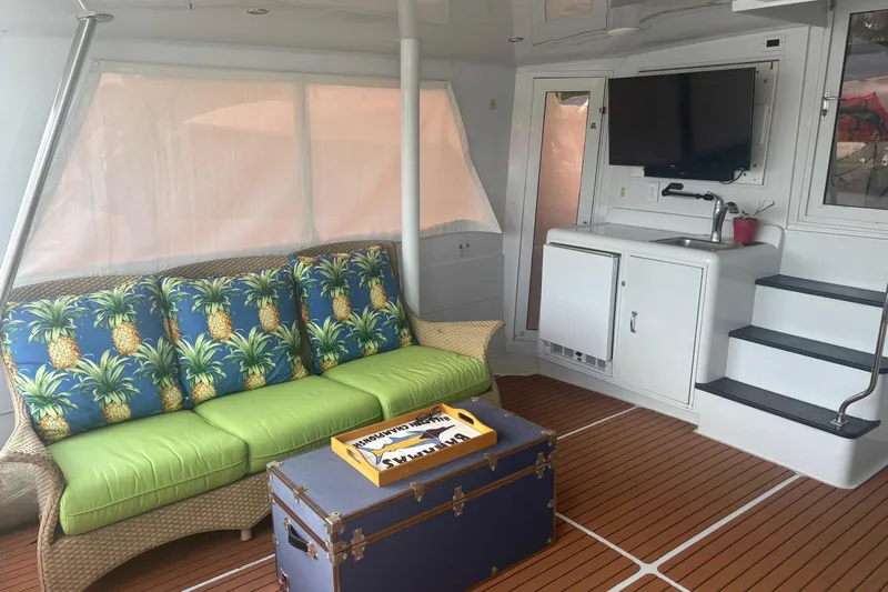  Yacht Photos Pics Interior of 1999 Hatteras 52 Cockpit Motor Yacht with tropical decor and modern amenities.