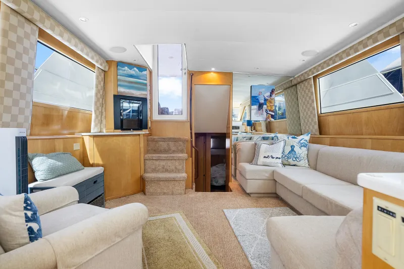  Yacht Photos Pics Luxurious interior of 1999 Hatteras 52 Cockpit Motor Yacht with elegant seating and decor.