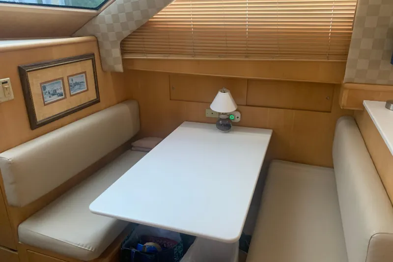  Yacht Photos Pics Interior of 1999 Hatteras 52 Cockpit Motor Yacht with cozy dining area.