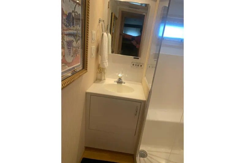  Yacht Photos Pics Bathroom interior of 1999 Hatteras 52 Cockpit Motor Yacht with sink and mirror.