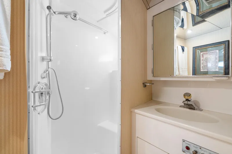  Yacht Photos Pics Bathroom interior of 1999 Hatteras 52 Cockpit Motor Yacht with shower and vanity.