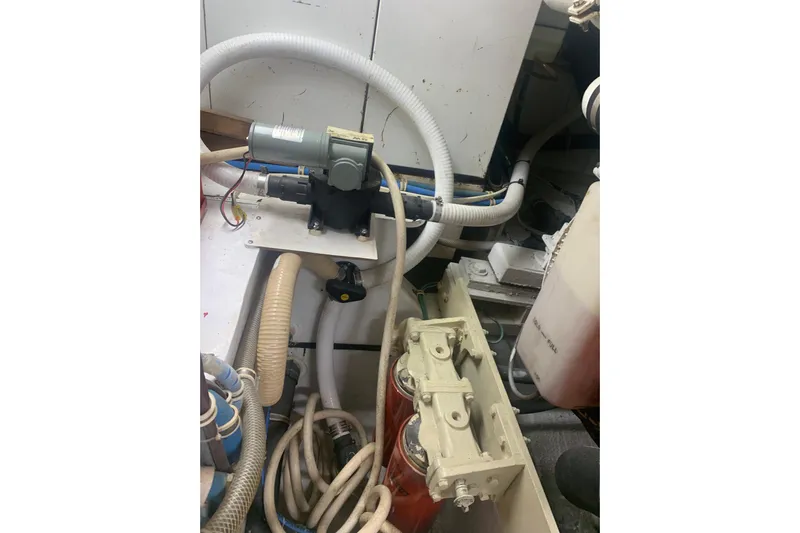  Yacht Photos Pics Engine room of 1999 Hatteras 52 Cockpit Motor Yacht with hoses and machinery.