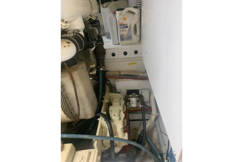  Yacht Photos Pics Engine room of 1999 Hatteras 52 Cockpit Motor Yacht with oil container and wiring.