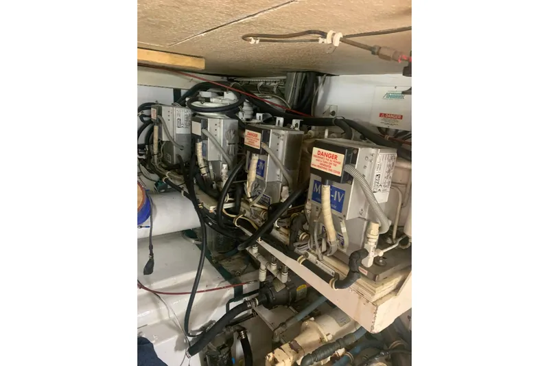  Yacht Photos Pics Engine room of 1999 Hatteras 52 Cockpit Motor Yacht with mechanical components.