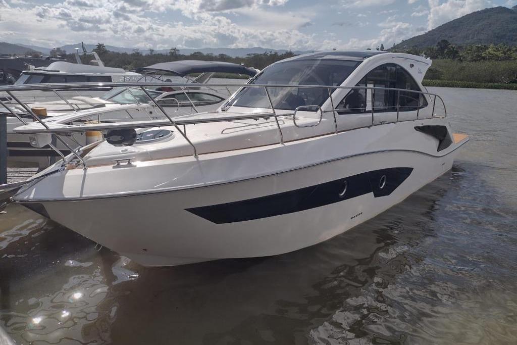 2023 Evolve 400HT yacht docked on a sunny day with scenic background.