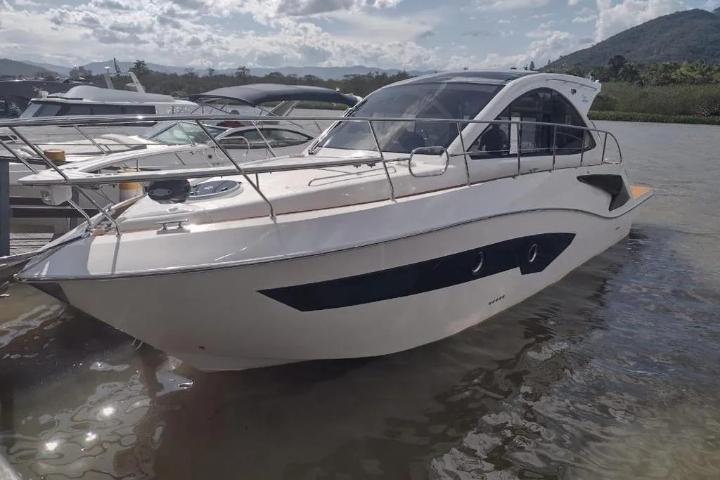 2023 Evolve 400HT yacht docked on a sunny day with scenic background.
