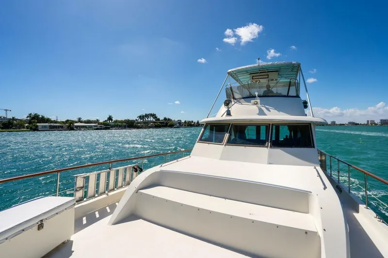 Dharma Yacht Photos Pics 1978 Hatteras 53 Yacht Fisherman cruising on a sunny day with clear blue skies.