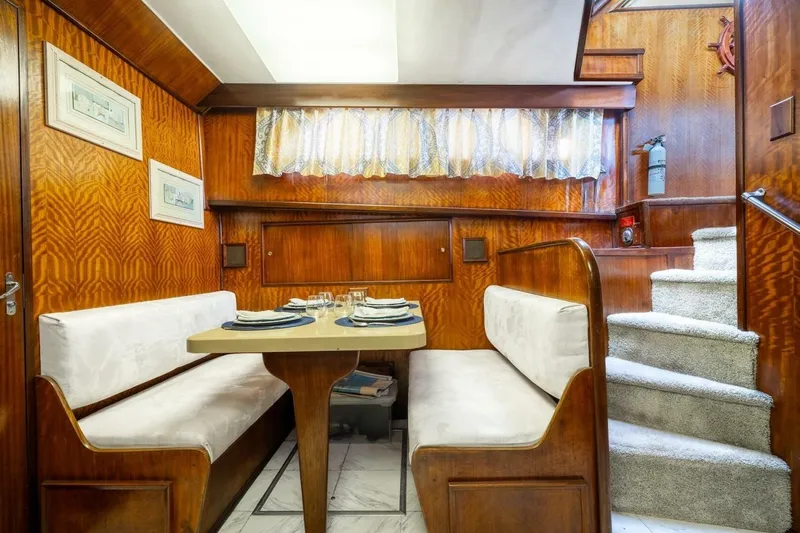 Dharma Yacht Photos Pics 1978 Hatteras 53 Yacht Fisherman interior dining area with wood paneling and cozy seating.