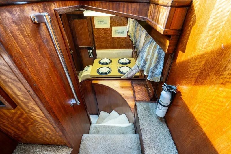 Dharma Yacht Photos Pics Interior of 1978 Hatteras 53 Yacht Fisherman with wooden finish and dining area.