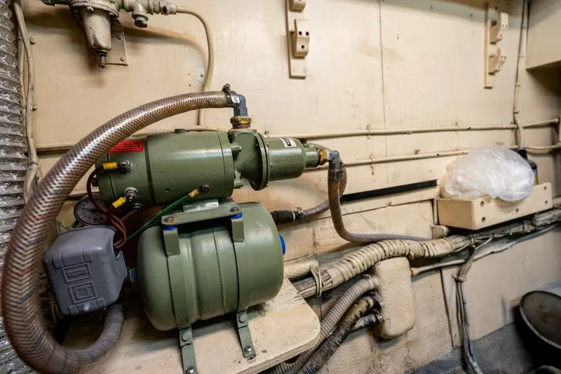 Dharma Yacht Photos Pics Engine room of 1978 Hatteras 53 Yacht Fisherman with mechanical equipment and piping.