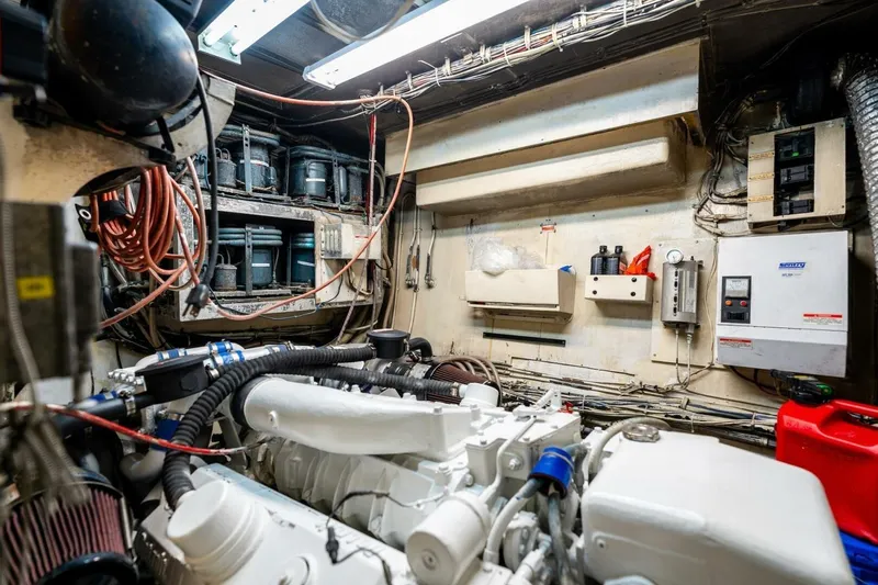 Dharma Yacht Photos Pics Engine room of a 1978 Hatteras 53 Yacht Fisherman with visible machinery and wiring.