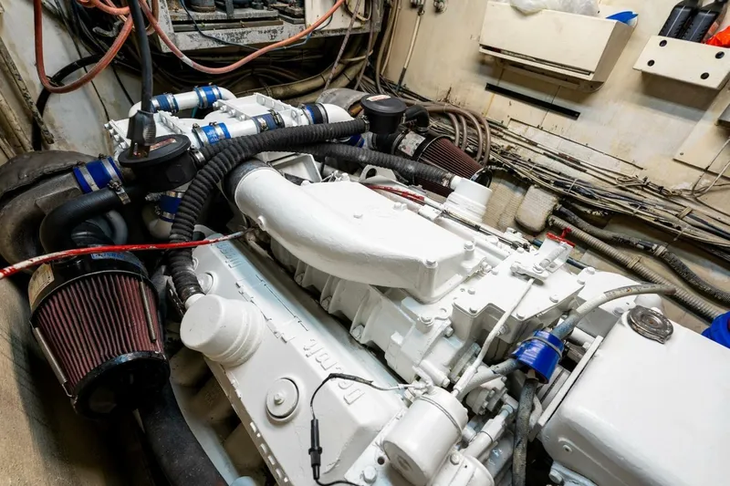 Dharma Yacht Photos Pics Engine room of a 1978 Hatteras 53 Yacht Fisherman, showcasing detailed machinery and components.