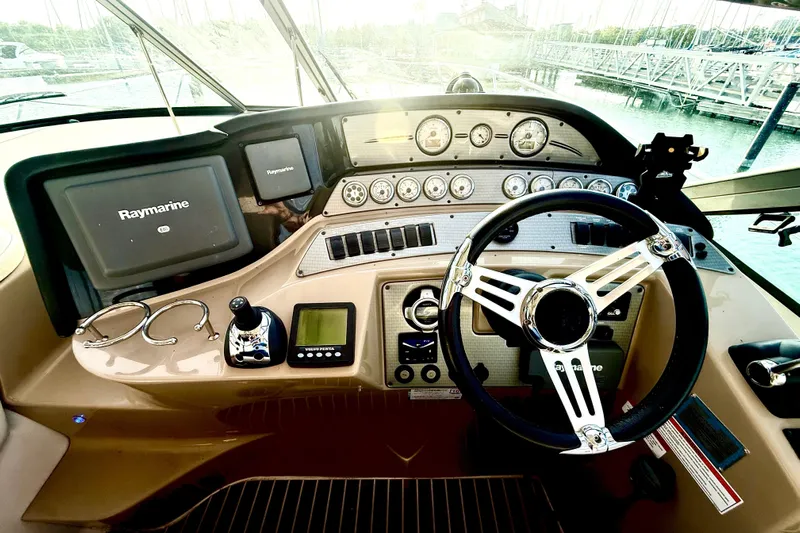 Fresh Off The Boat Yacht Photos Pics 2008 Four Winns 378 Vista boat dashboard with steering wheel and navigation instruments.