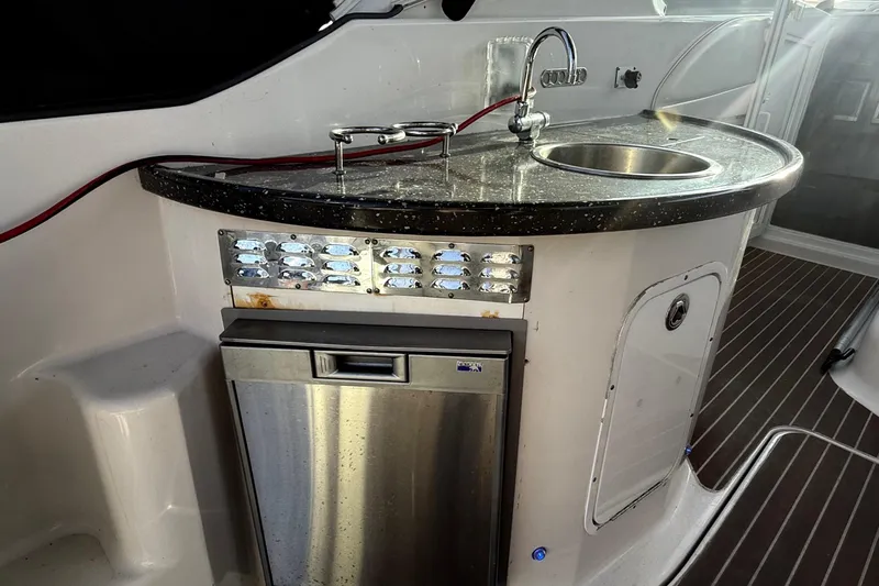 Fresh Off The Boat Yacht Photos Pics 2008 Four Winns 378 Vista yacht kitchenette with sink and stainless steel appliances.