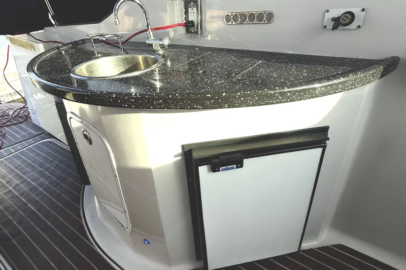 Fresh Off The Boat Yacht Photos Pics 2008 Four Winns 378 Vista boat kitchenette with sink and mini fridge.