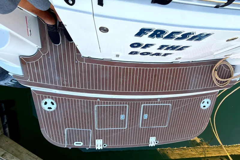 Fresh Off The Boat Yacht Photos Pics 2008 Four Winns 378 Vista boat with teak deck and "Fresh of the Boat" lettering.