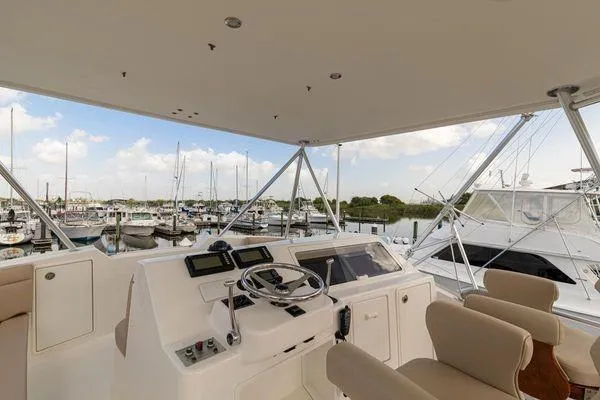 No Name Yacht Photos Pics Helm of 2008 Ocean Yachts 46SS with marina view, featuring modern controls and seating.