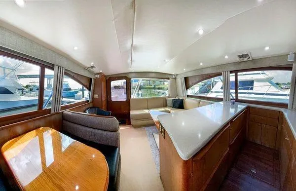 No Name Yacht Photos Pics Luxurious interior of 2008 Ocean Yachts 46SS with spacious seating and elegant wood finishes.
