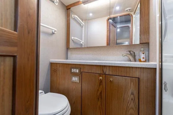 No Name Yacht Photos Pics Luxurious bathroom in 2008 Ocean Yachts 46SS, featuring wood cabinetry and modern fixtures.