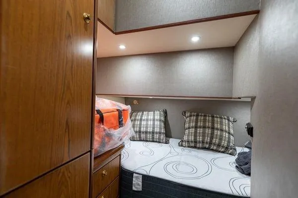 No Name Yacht Photos Pics Cozy cabin interior of 2008 Ocean Yachts 46SS with bed, pillows, and storage.