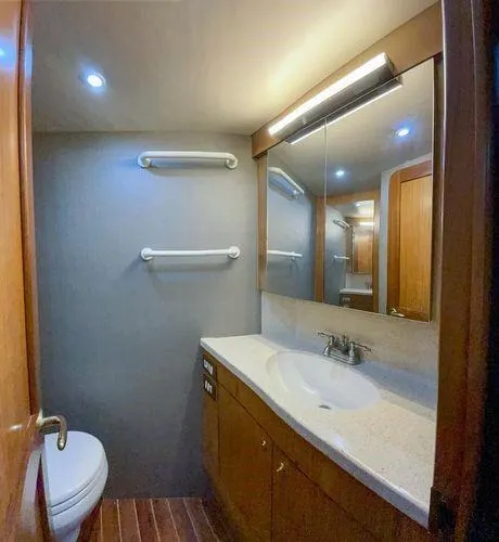 No Name Yacht Photos Pics Luxurious bathroom in 2008 Ocean Yachts 46SS, featuring modern fixtures and wooden cabinetry.