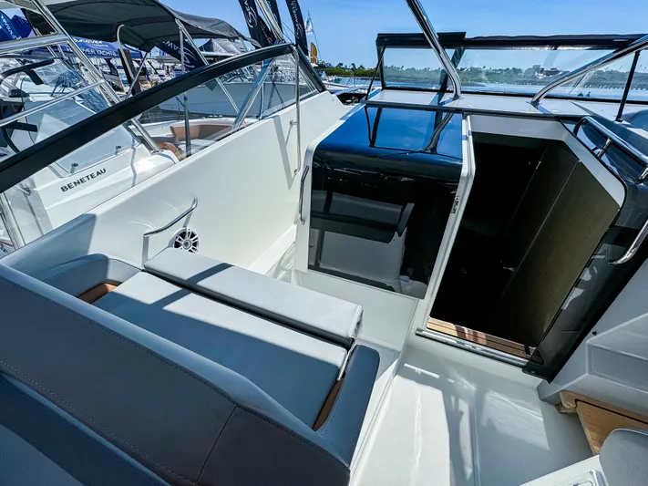  Yacht Photos Pics 2024 Beneteau Flyer 10 boat interior with seating and helm, showcasing modern design.