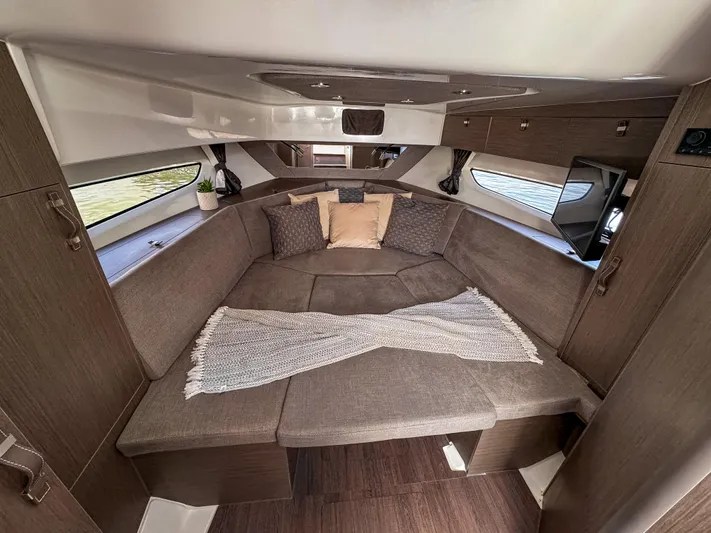  Yacht Photos Pics 2024 Beneteau Flyer 10 cabin interior with cozy seating and modern design.