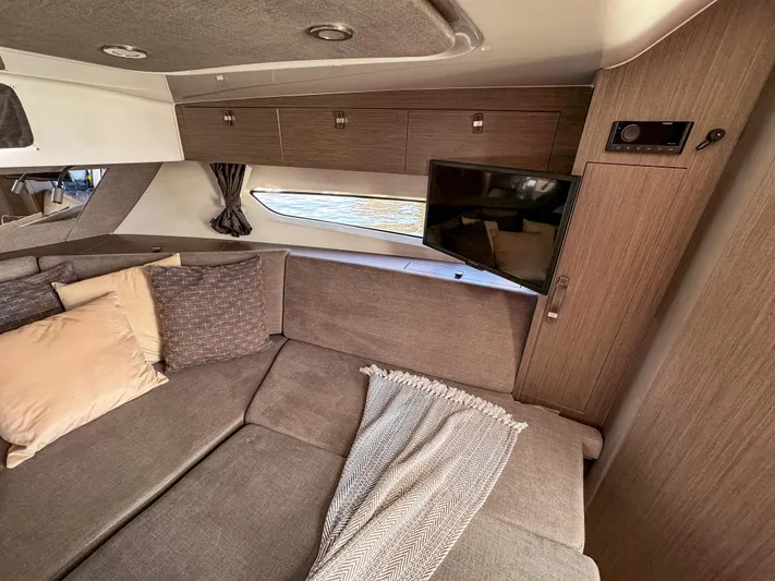  Yacht Photos Pics 2024 Beneteau Flyer 10 interior with cozy seating, TV, and modern wood finishes.