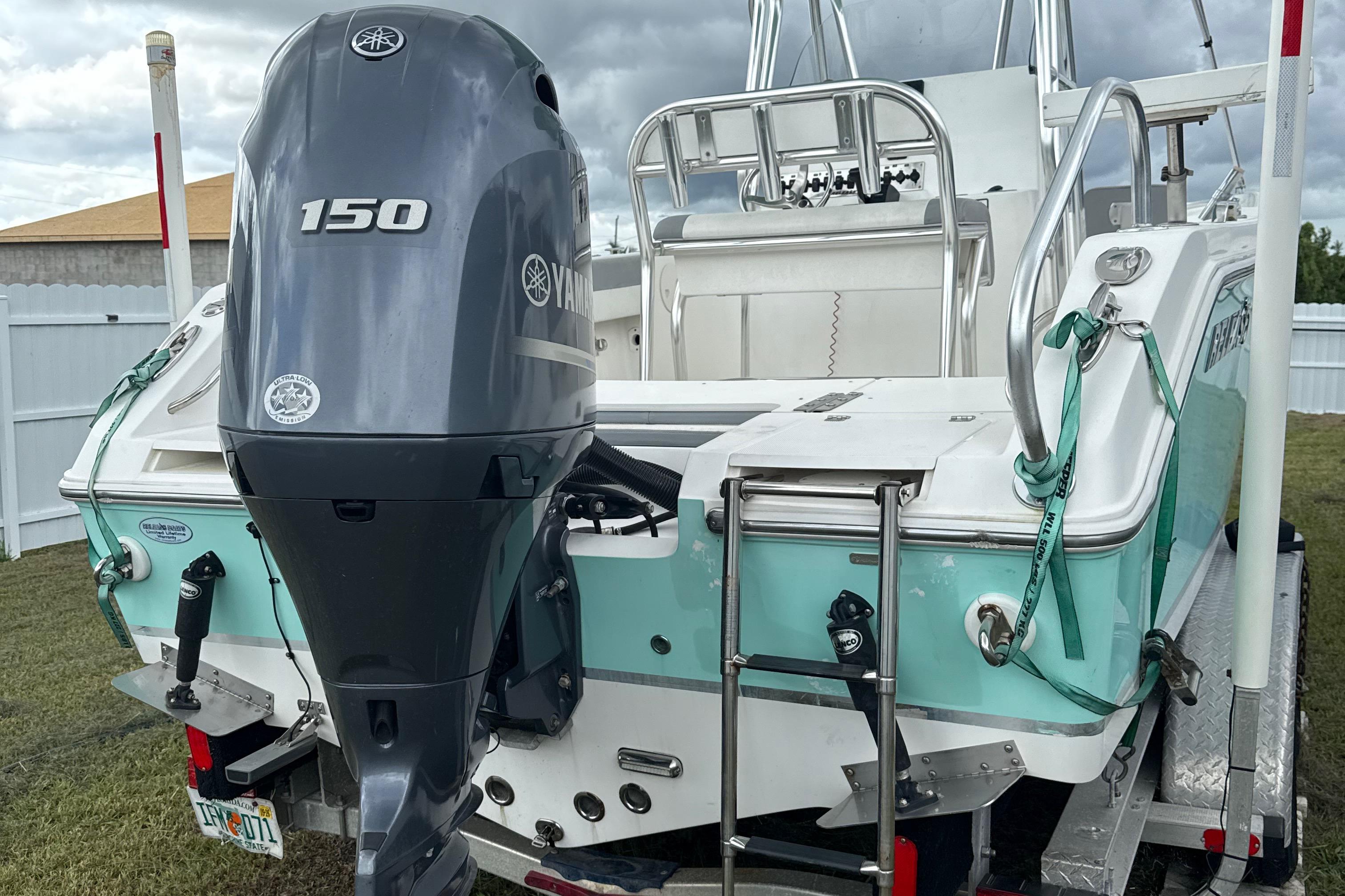 2018 Release 208 RX boat with Yamaha 150 outboard motor, parked on trailer.