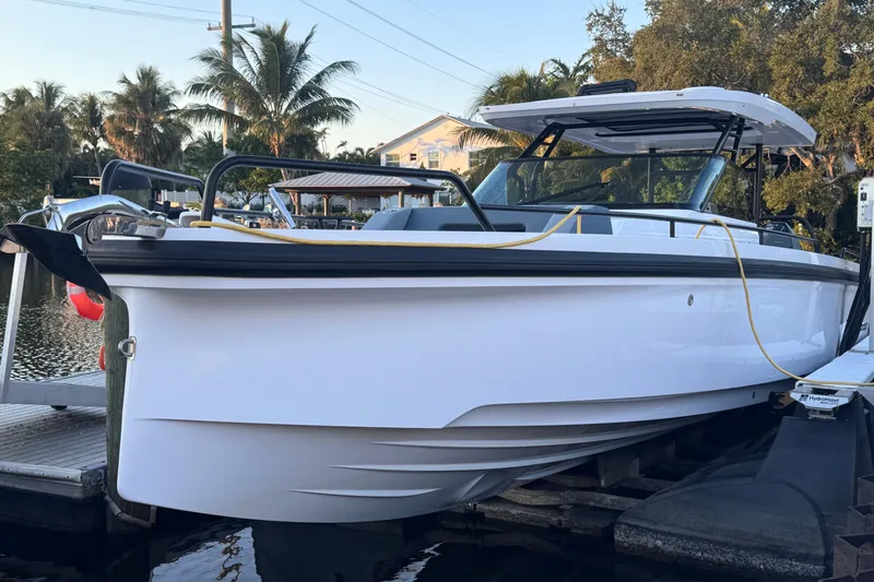 Axopar 37 Suntop Yacht Photos Pics 2024 Axopar 37 SunTop boat docked, showcasing sleek design and modern features.