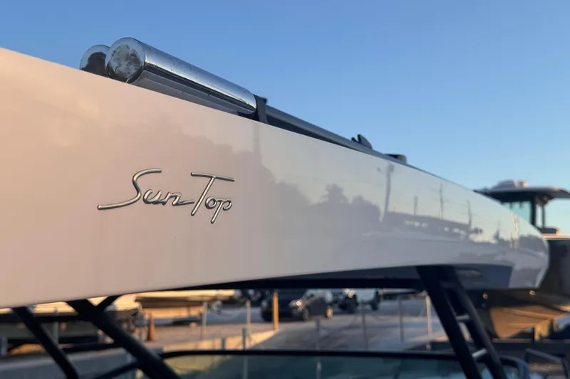 Axopar 37 Suntop Yacht Photos Pics 2024 Axopar 37 SunTop boat detail with sleek design and logo.