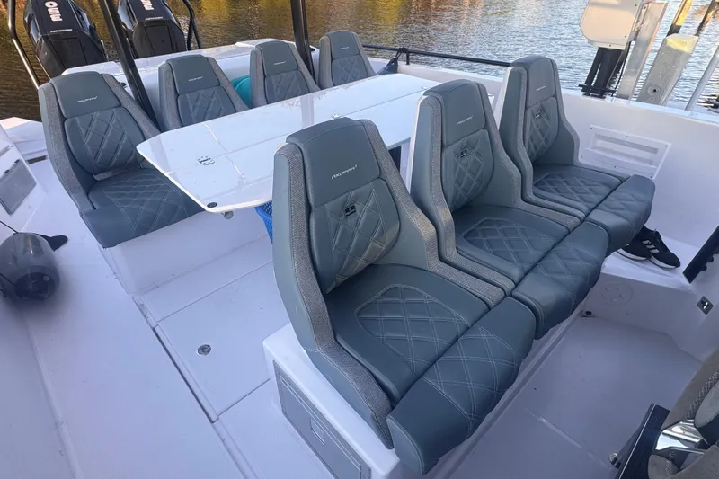 Axopar 37 Suntop Yacht Photos Pics 2024 Axopar 37 SunTop boat interior with stylish seating and table setup.