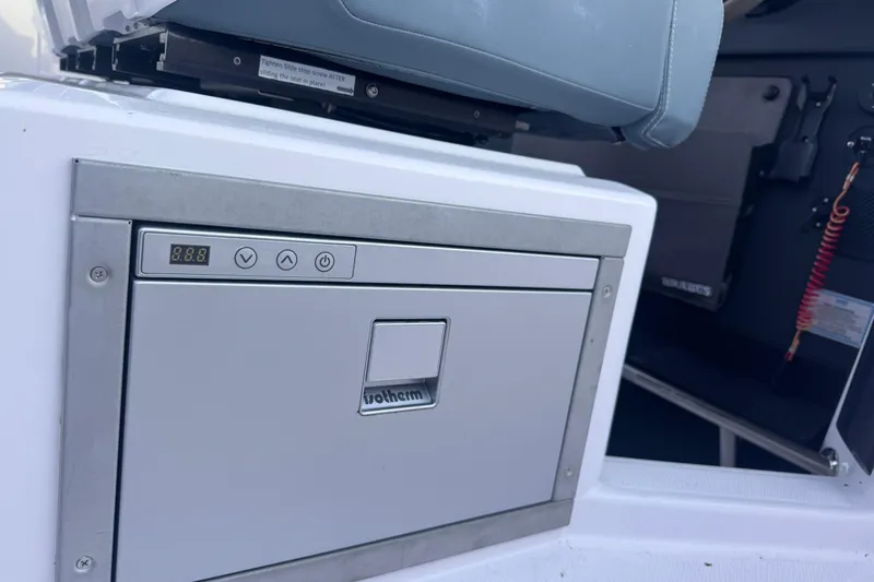 Axopar 37 Suntop Yacht Photos Pics 2024 Axopar 37 SunTop boat interior with a built-in control panel.