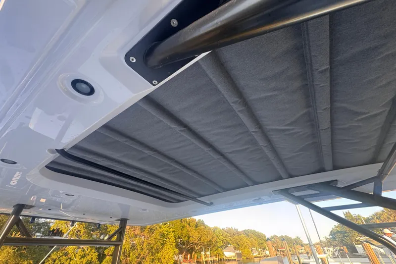 Axopar 37 Suntop Yacht Photos Pics 2024 Axopar 37 SunTop boat roof detail with scenic background.